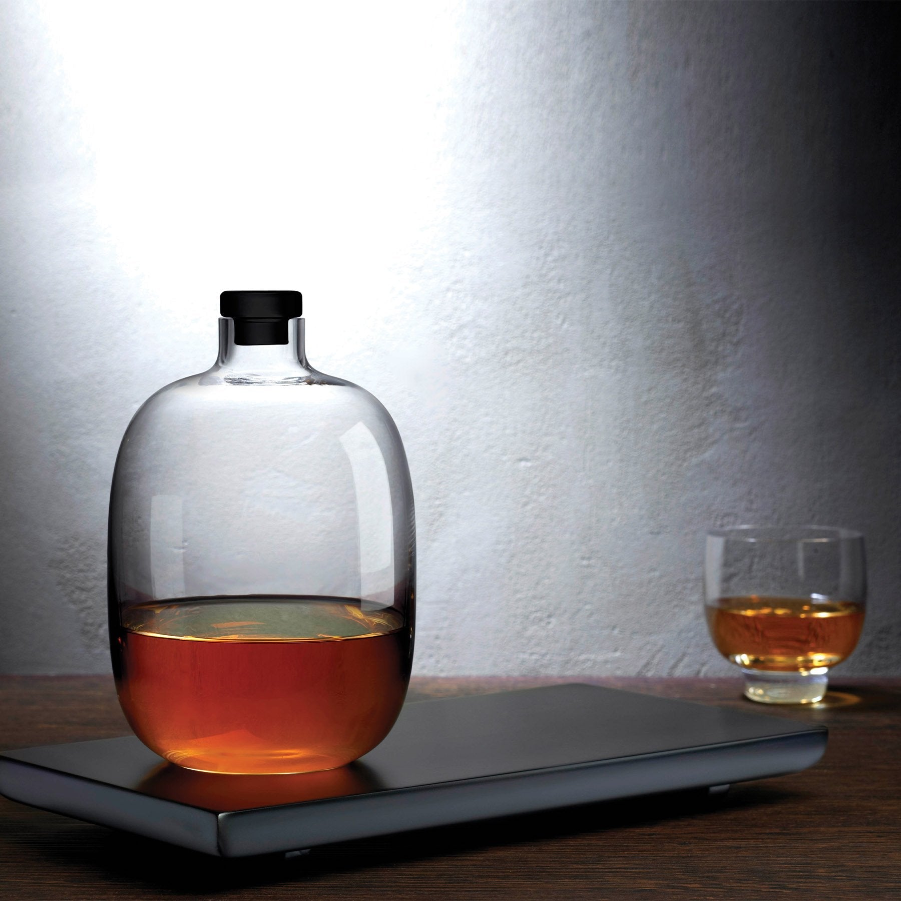 malt whiskey bottle with wooden tray by nude at adorn.house
